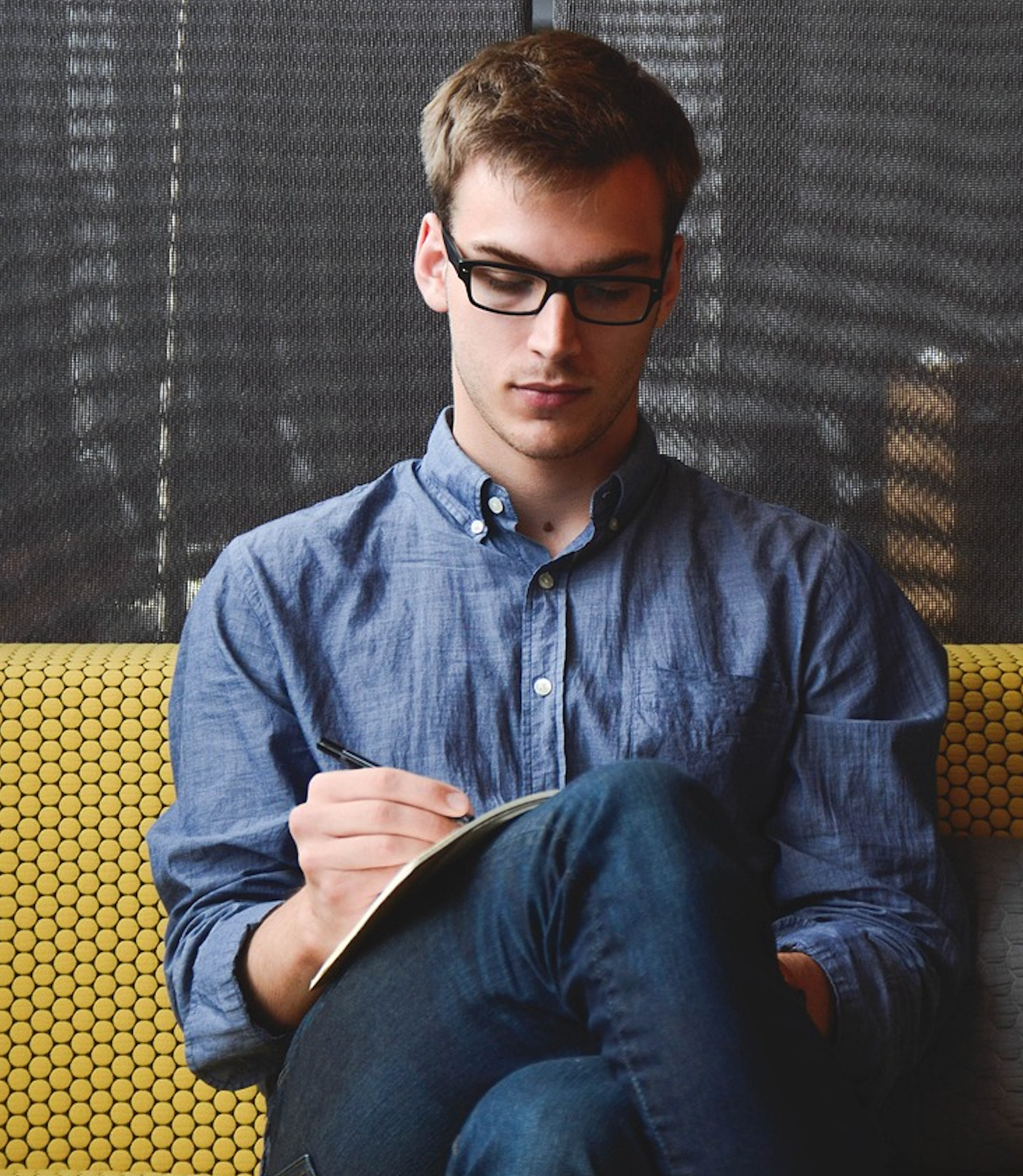 Man sitting with legs crossed analyzing a property